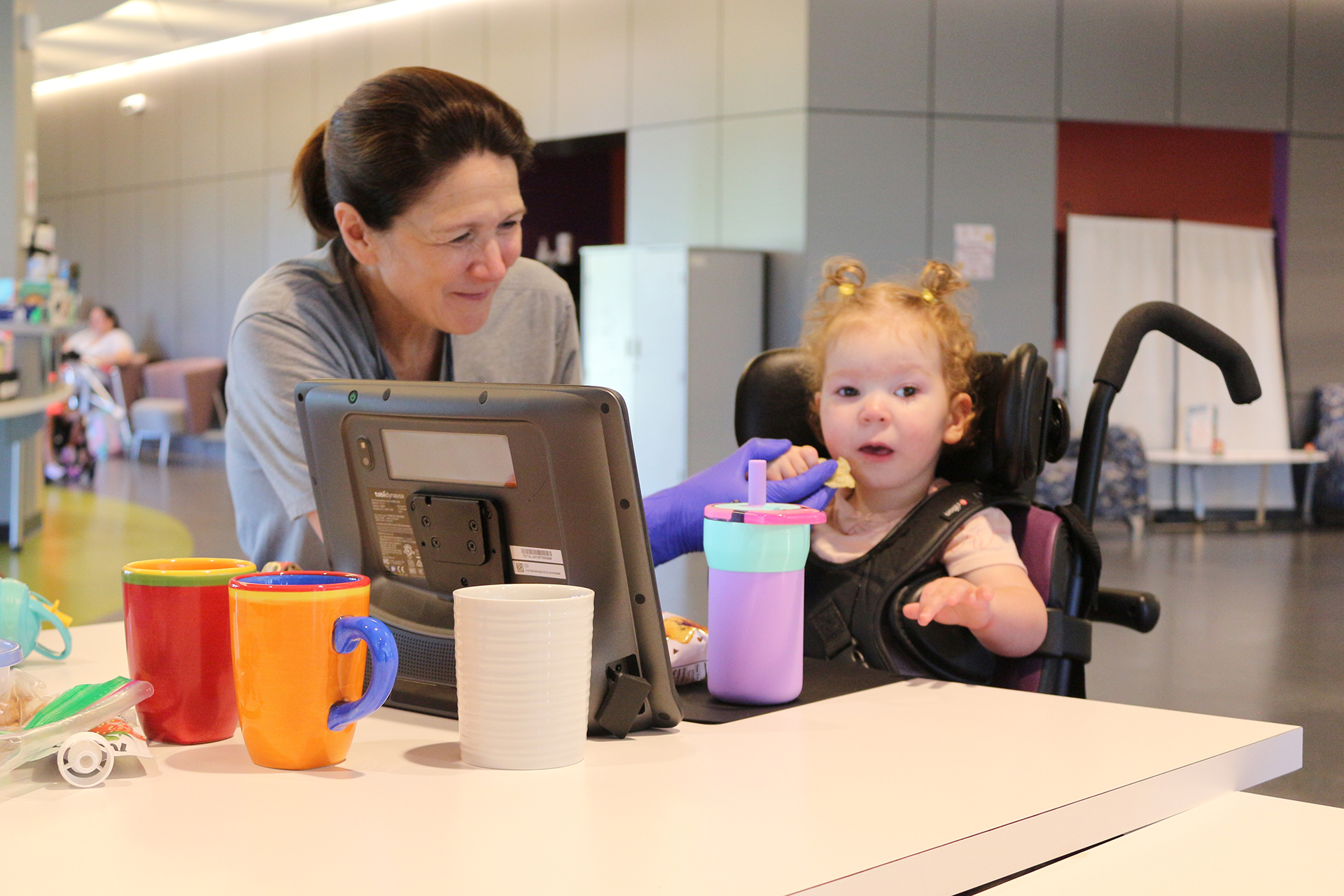 Female therapist with a female Ranken Jordan patient during an outpatient camp session