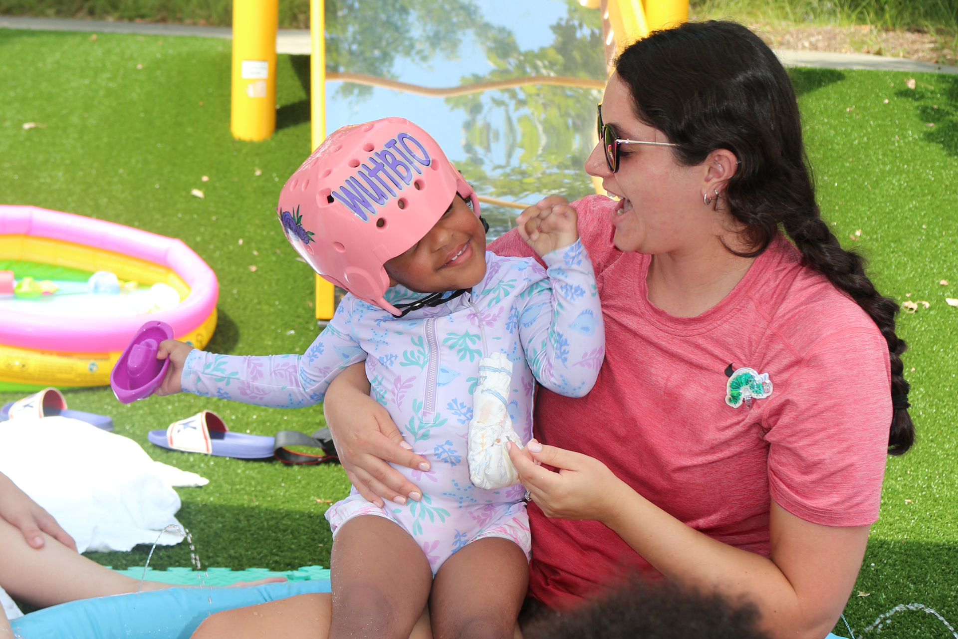 Conjoined twins enjoying outdoor play therapy at Ranken Jordan